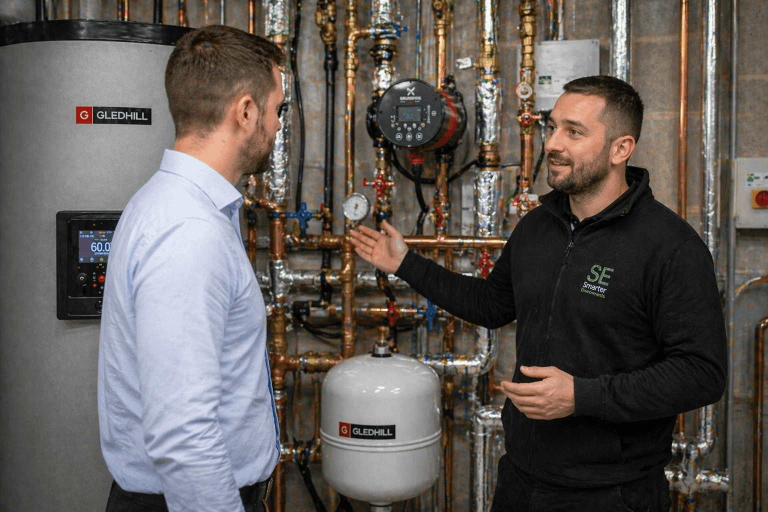 Gas Safe registered engineer conducting commercial hot water system consultation in Bury St Edmunds