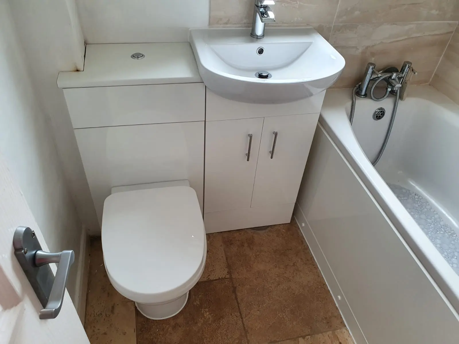 Finished bathroom with toilet, basin, bath and fitted plumbing fixtures