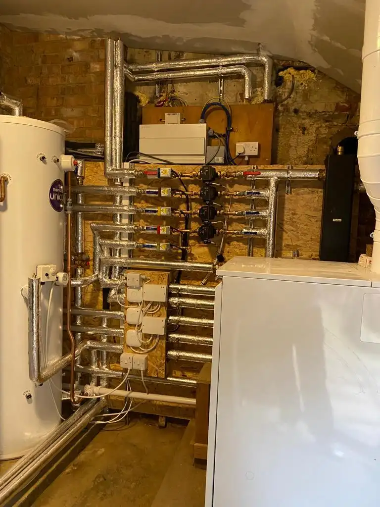 Hot water cylinder, pumps and insulated heating pipework installed by Anglian PHE