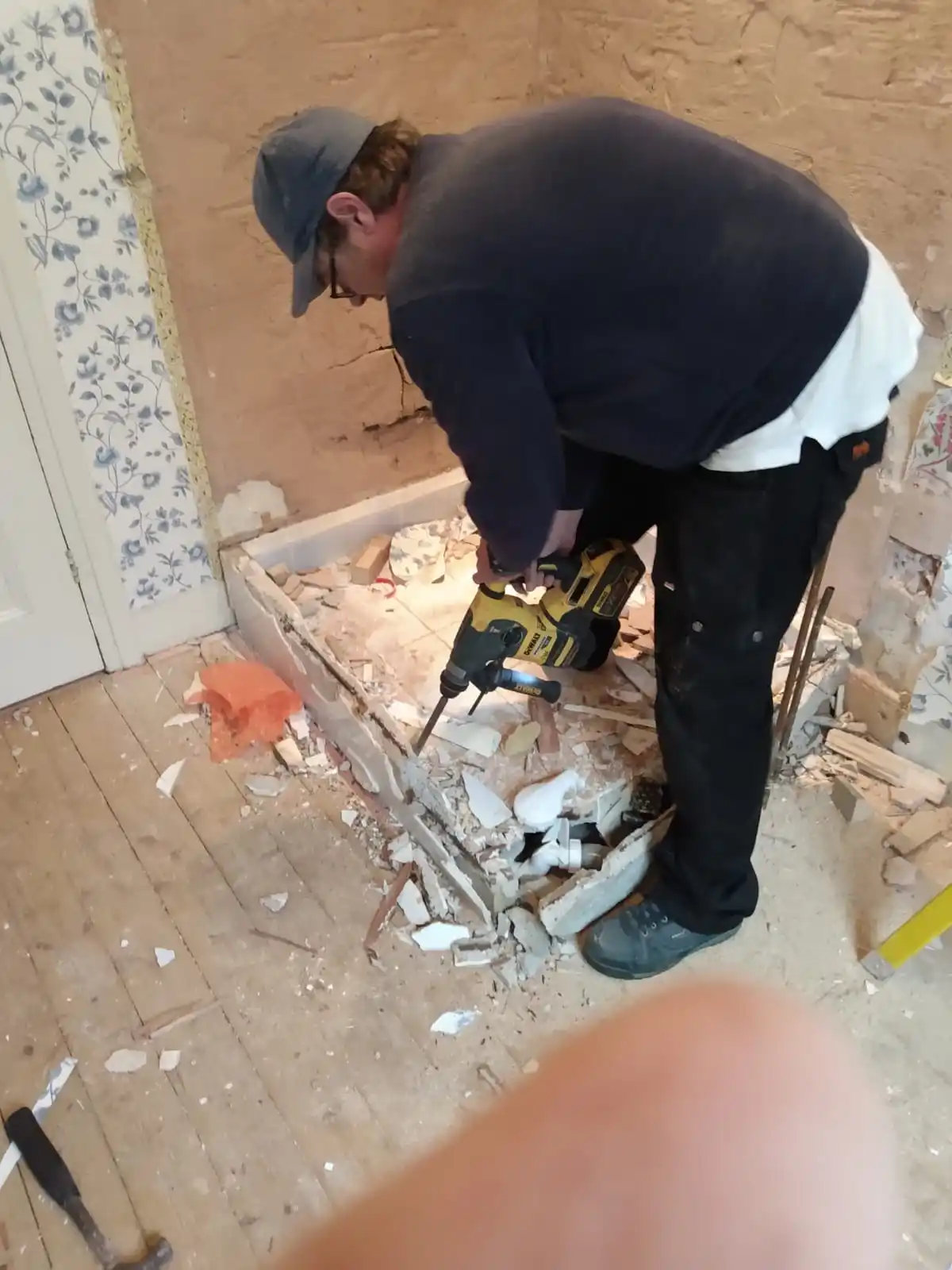 Plumber carrying out bathroom plumbing and pipework repair work