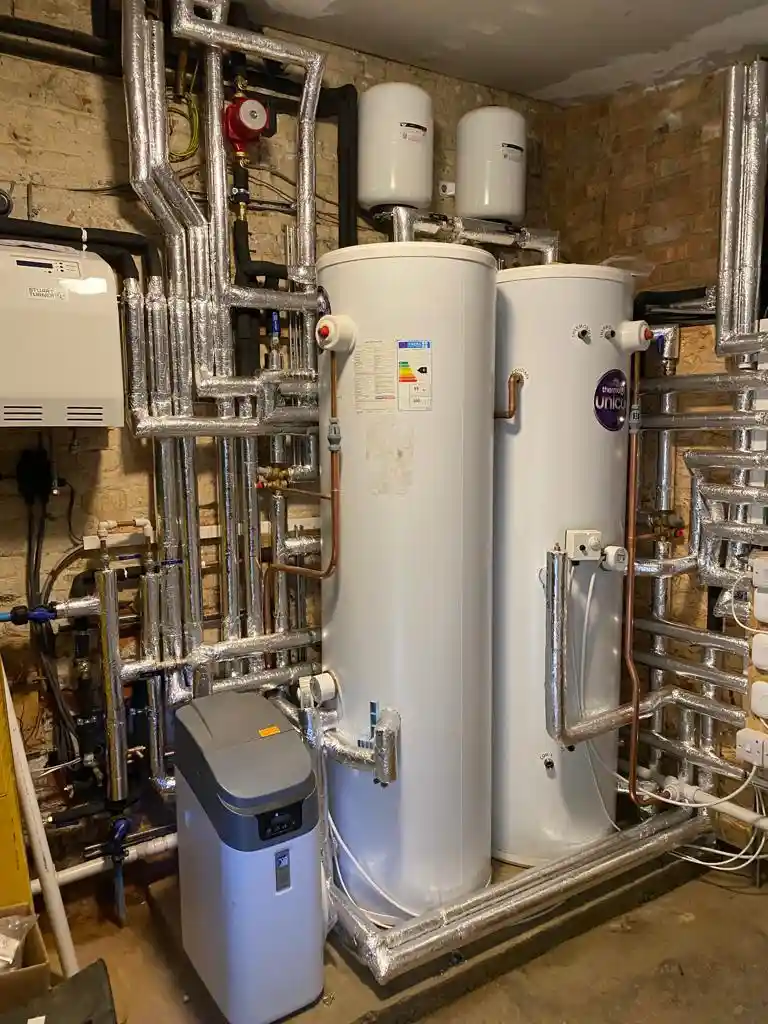 Plumbing and heating system with hot water cylinders and insulated pipework